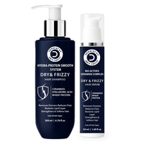 Dermistry Hair Systems Hydra-Protein Smooth System Dry & Frizzy Hair Shampoo in a dark navy blue pump bottle next to its matching Dry & Frizzy Hair Serum in a dark navy blue and white pump bottle, on a white background.