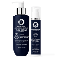 Two dark navy blue haircare bottles from Derma Science on a white background: a larger pump bottle of Curl Define Complex Shampoo and a smaller pump bottle of Curl Define Serum.